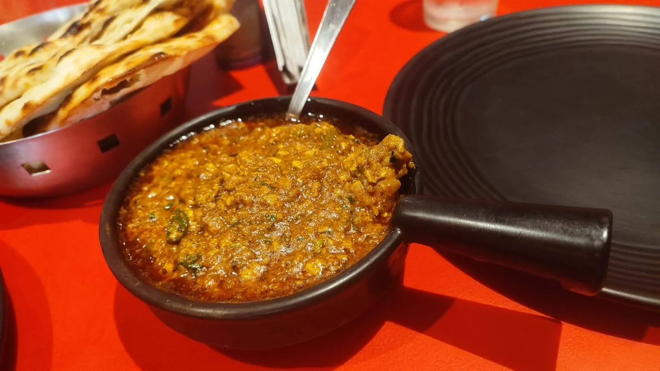 Rich dal-based curry served with butter naan — classic Mughlai comfort dish